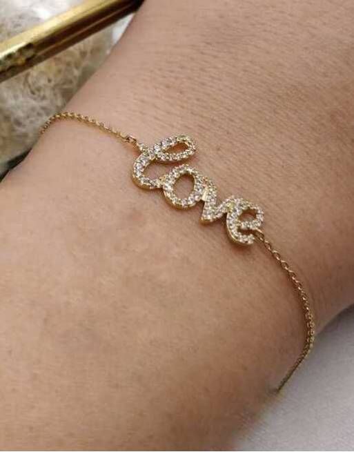 00-1034 Pulsera oro de 18K con motivo love montada con pavé de circonitas