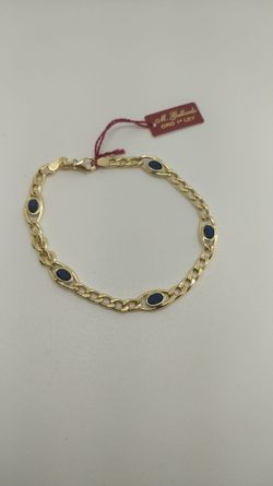 PU458A Pulsera mujer en oro 18k cadena barbada con 5 piedras azules, elegante y sofisticada